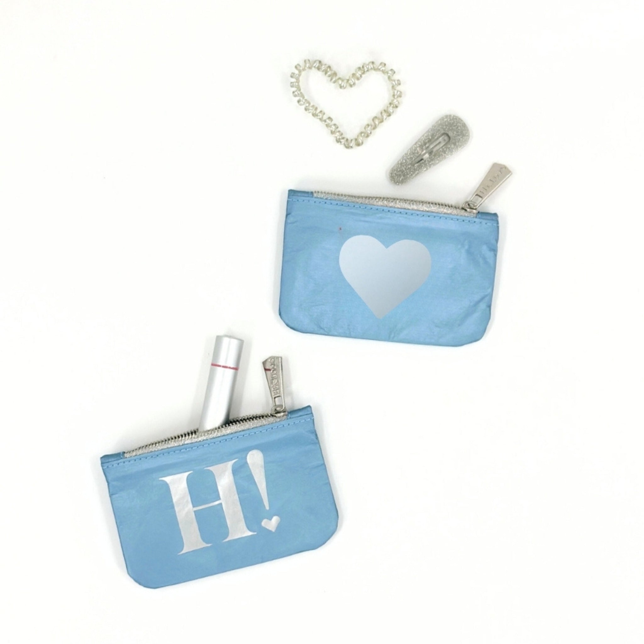 Set of two mini zipper gift card pouches in shimmer ice blue color with silver heart and 'H!' logo