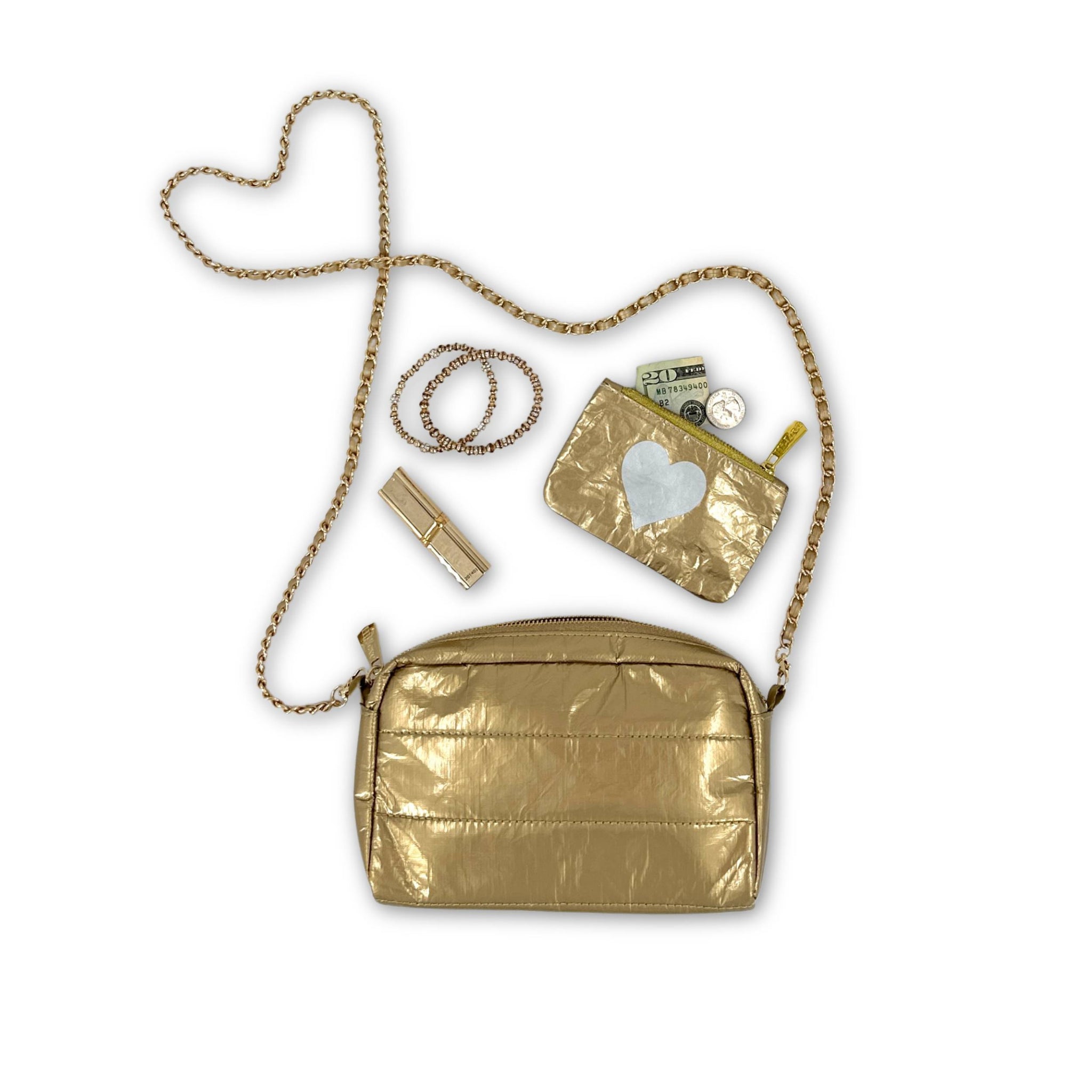 Gold mini zipper pouch and lipstick coming out of gold mini puffer clutch with gold chain 