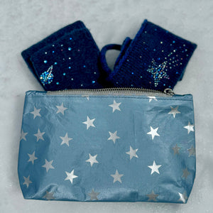 Shimmer ice blue with silver stars zipper pouch laying in the snow