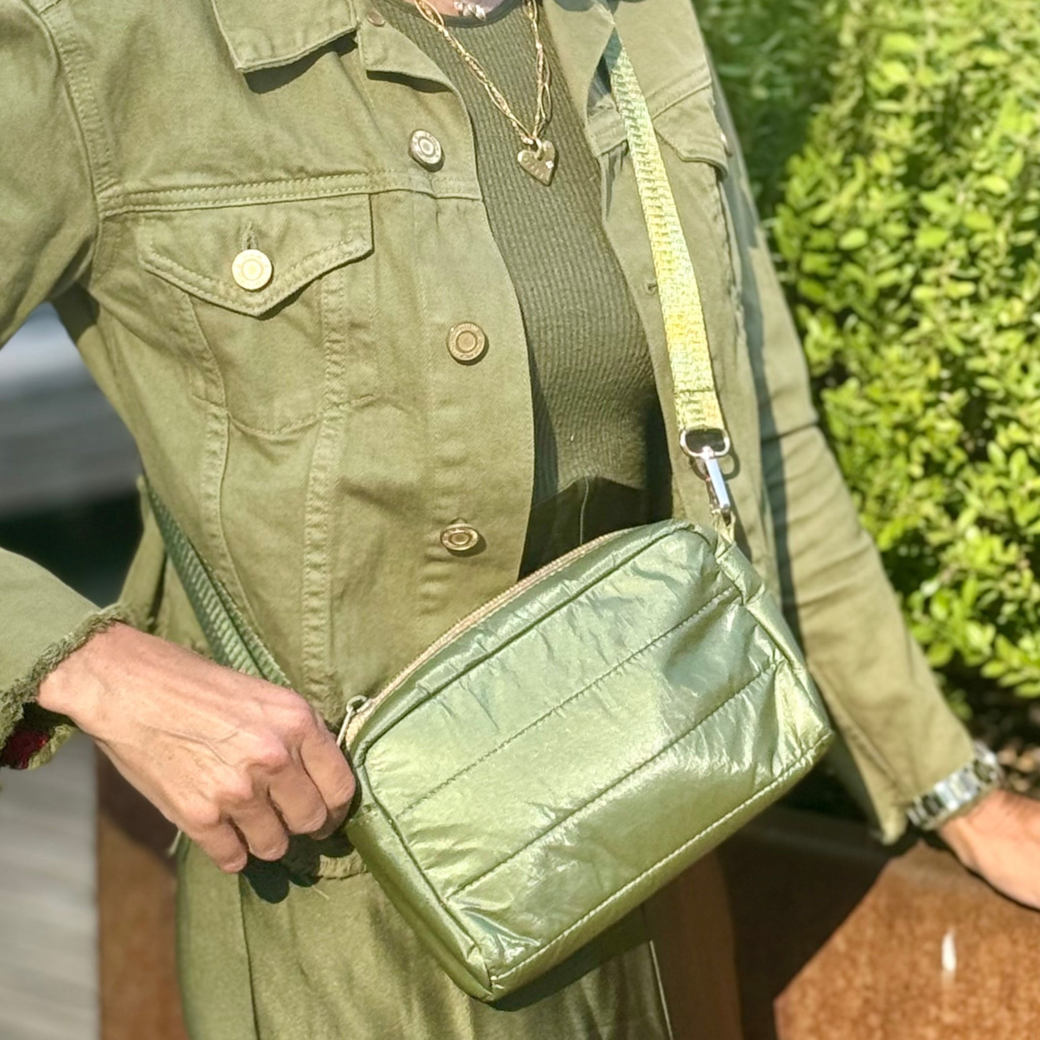 Shimmer olive green mini puffer purse glistening in the sun