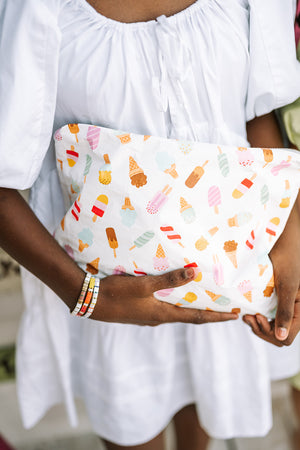 Teen holding a popsicle pattern zipper pouch