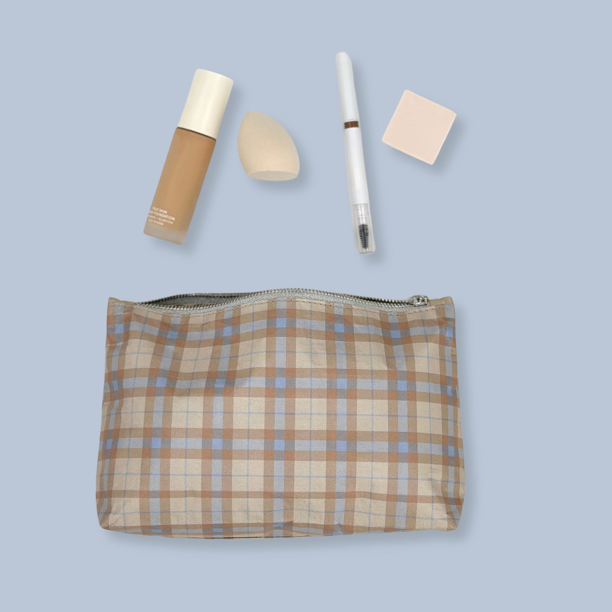 Beige and ice blue plaid cosmetic zipper pouch with makeup inside