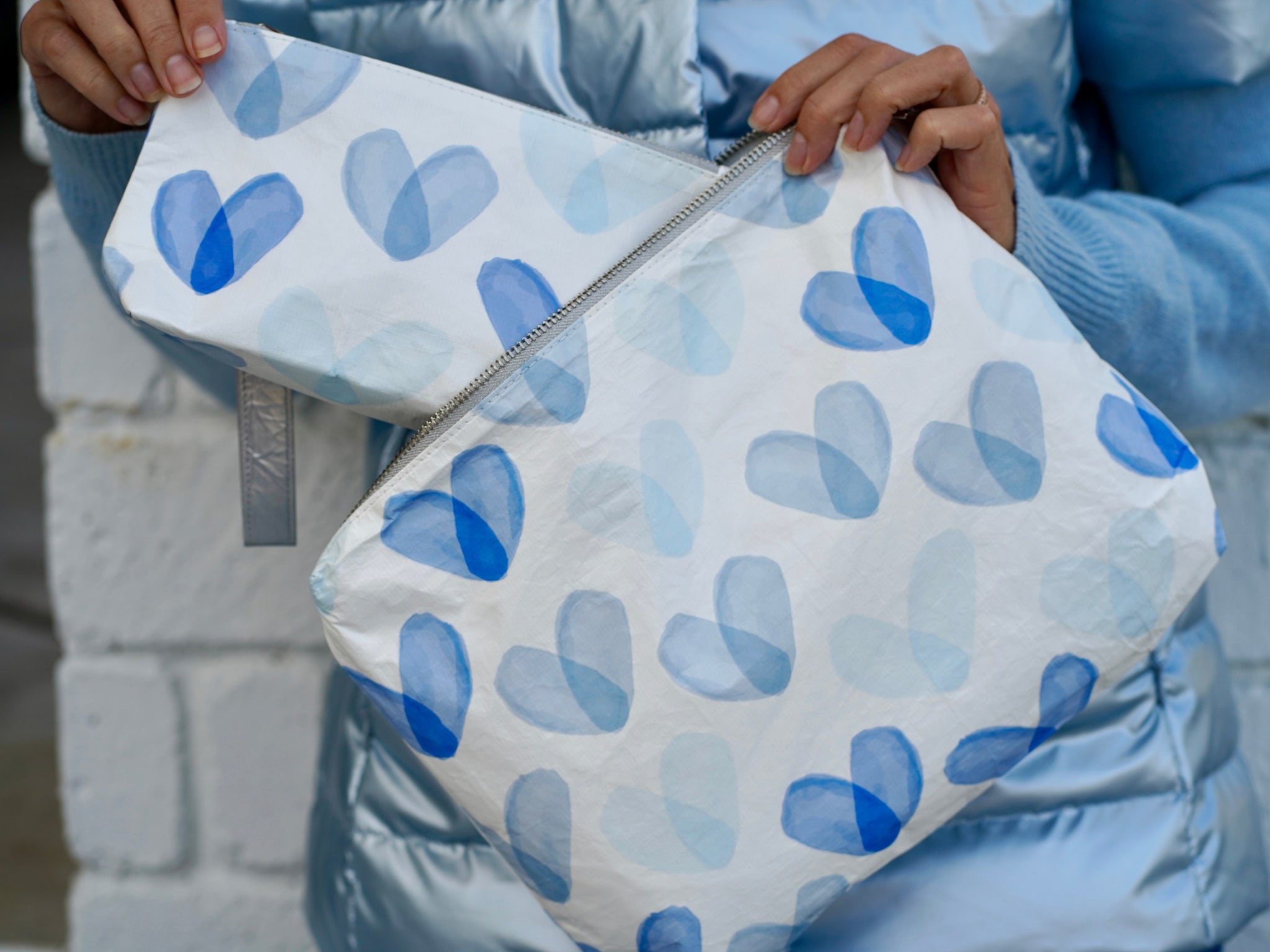 Medium and mini zipper pouches in white with hearts in different shades of blue